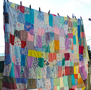 A traditional Newfoundland crazy quilt hangs on the line to dry.